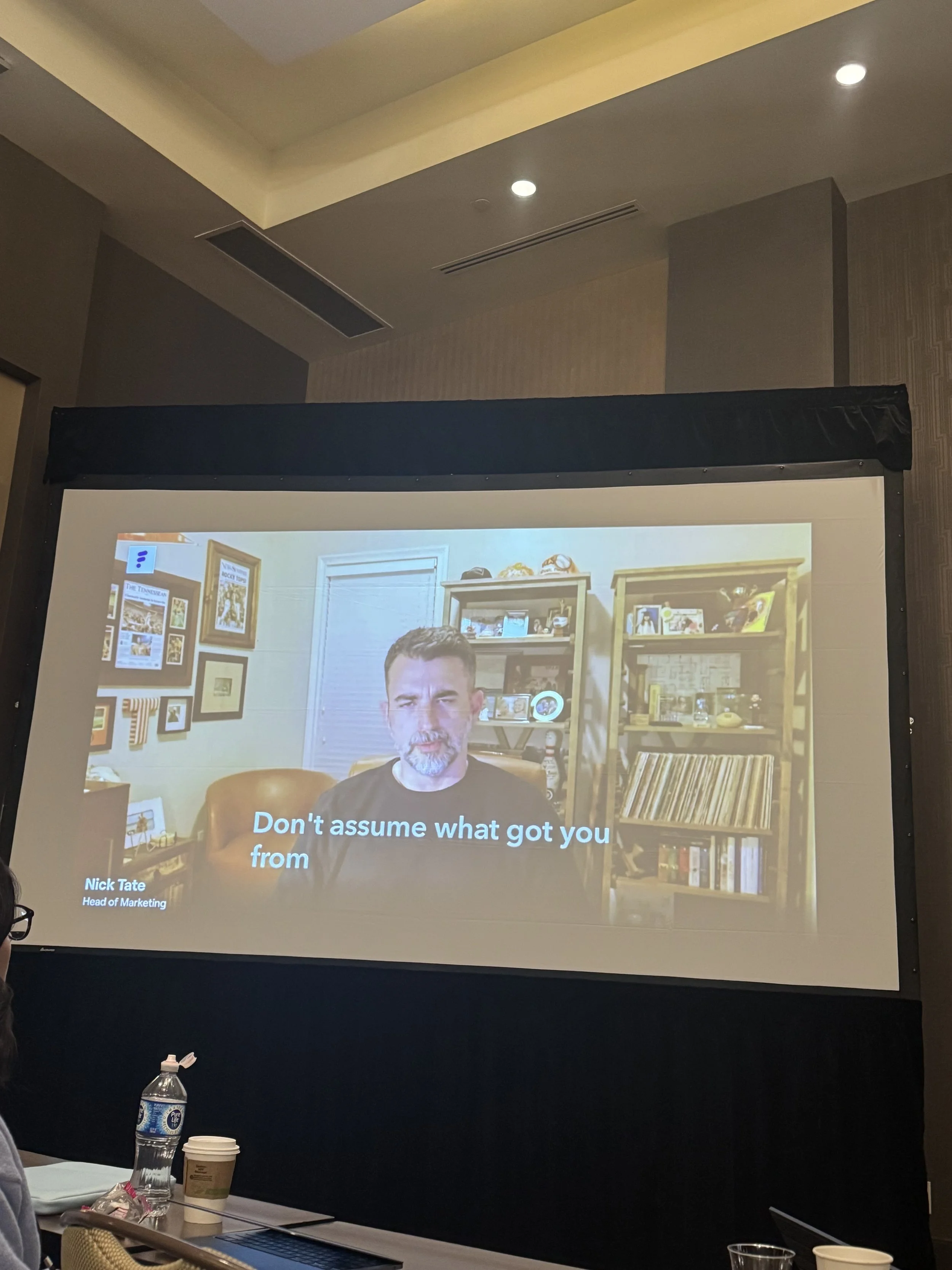 Nick Tate speaking on screen during an all-hands kickoff